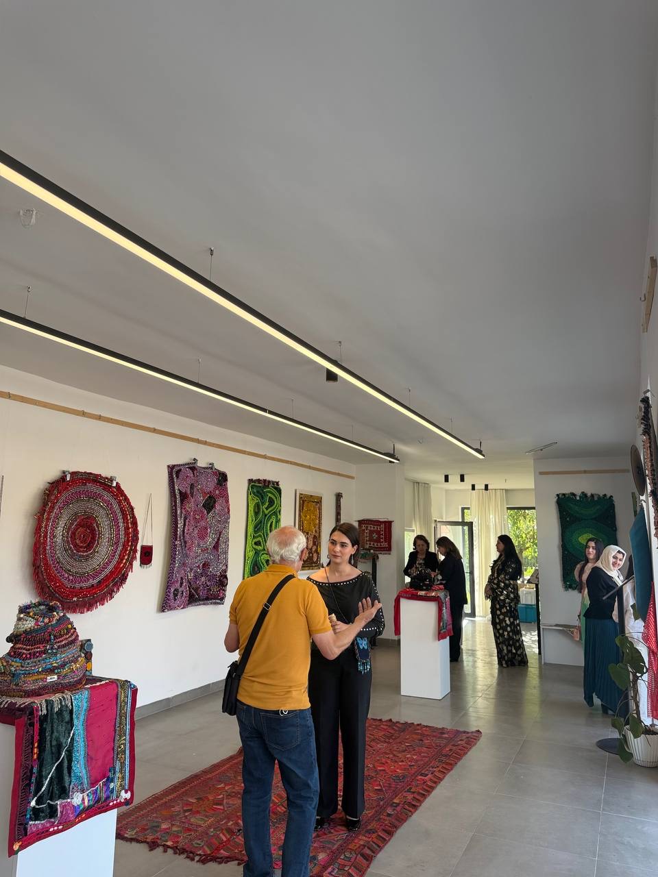 Lana talking with a visitor at her solo exhibition