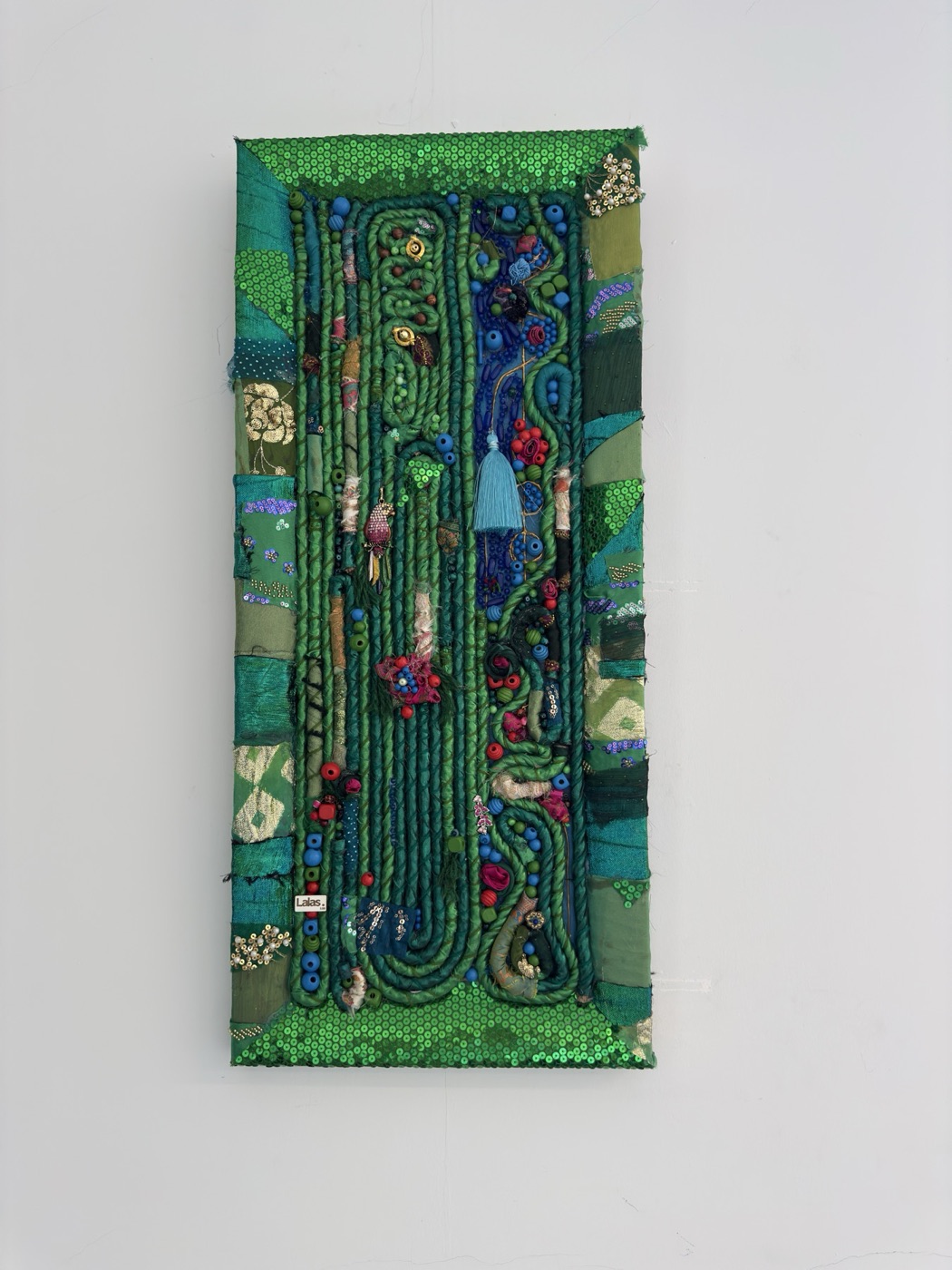 Green wall rug made from recycled fabrics, sequins and beads
